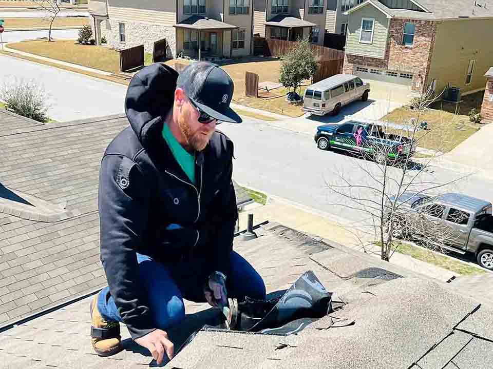 Roofer Repairing Residential Roof