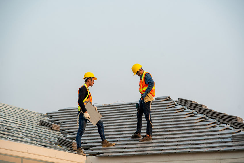 Roofer conversing with a homeowner
