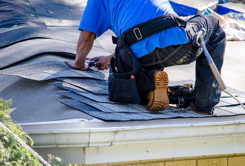 Roofer fixing a roof