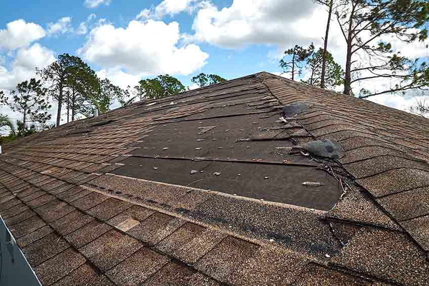 Damaged roof being inspected